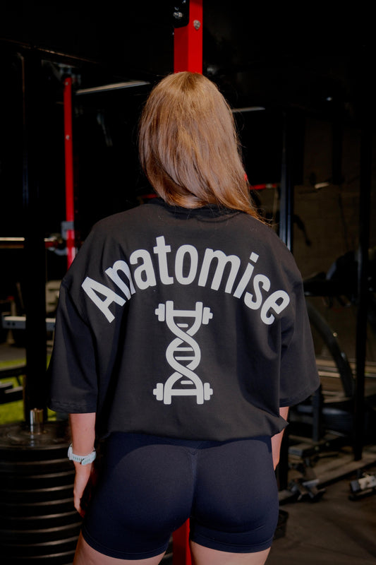 Female wearing black oversized anatomise t-shirt from back