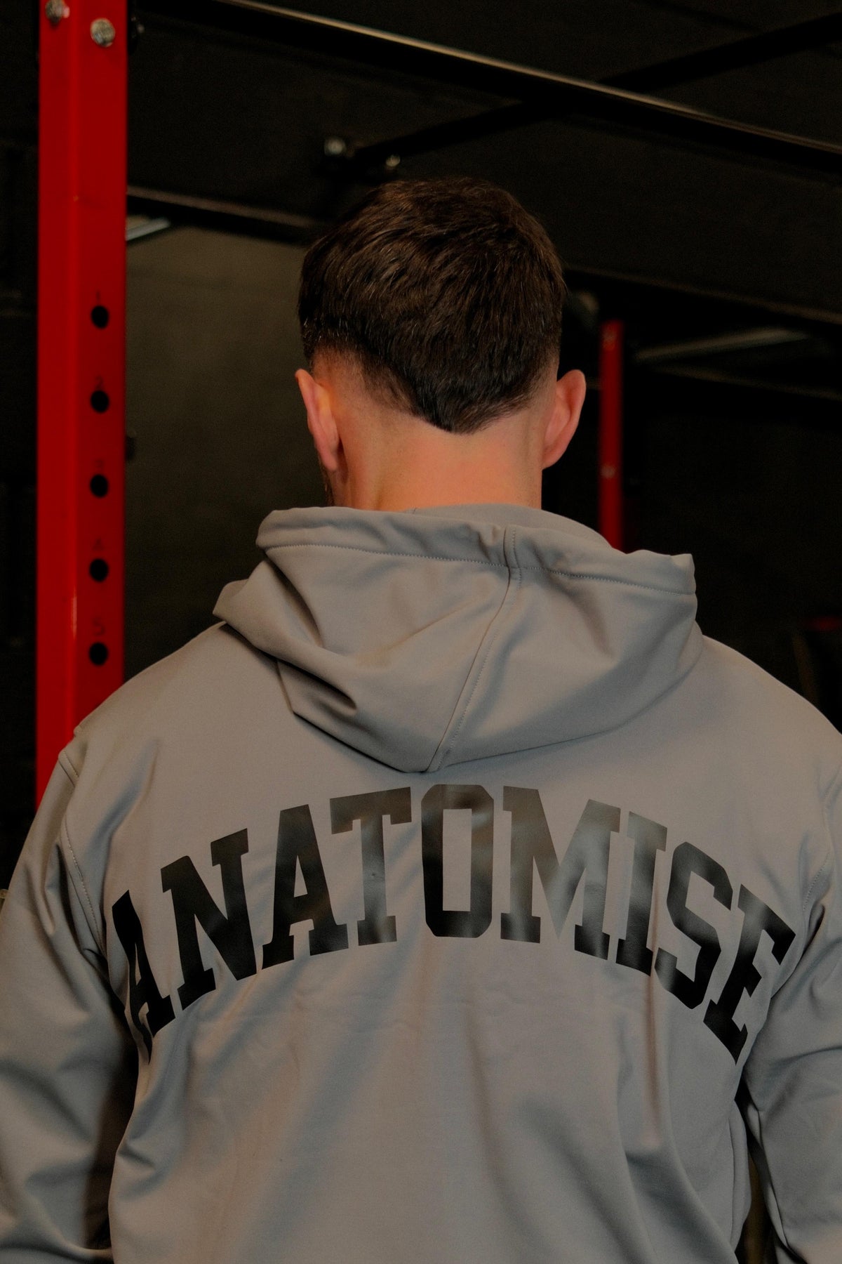 Male wearing anatomise pebble grey hoodie from back